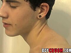 Inked gay teen 18+ strokes his big cock in the bath. Then he fucks his tight ass with a dildo solo.