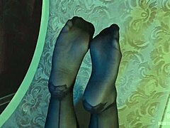 Sexy goddess teases with her feet in black pantyhose.