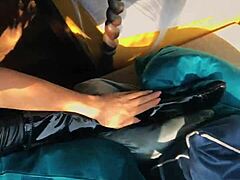 Woman shows off in wetlook suit and patent leather boots