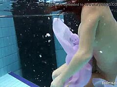 Aneta shows big tits in purple dress underwater in pool
