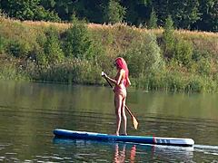 Sup and pink micro bikini in outdoor nature public flashing setting